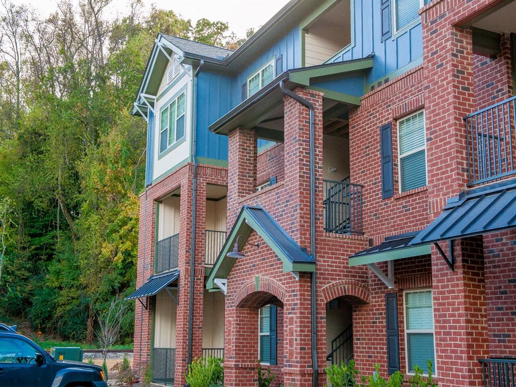 a brick apartment building with a car parked in front of it