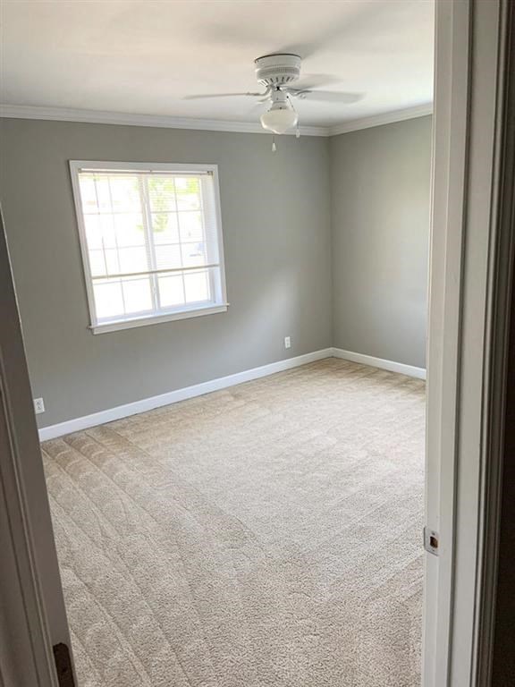 an empty room with a ceiling fan and a window