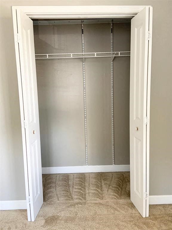 an empty closet with empty shelves and doors