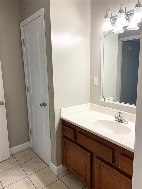 a bathroom with a sink and a mirror and a door