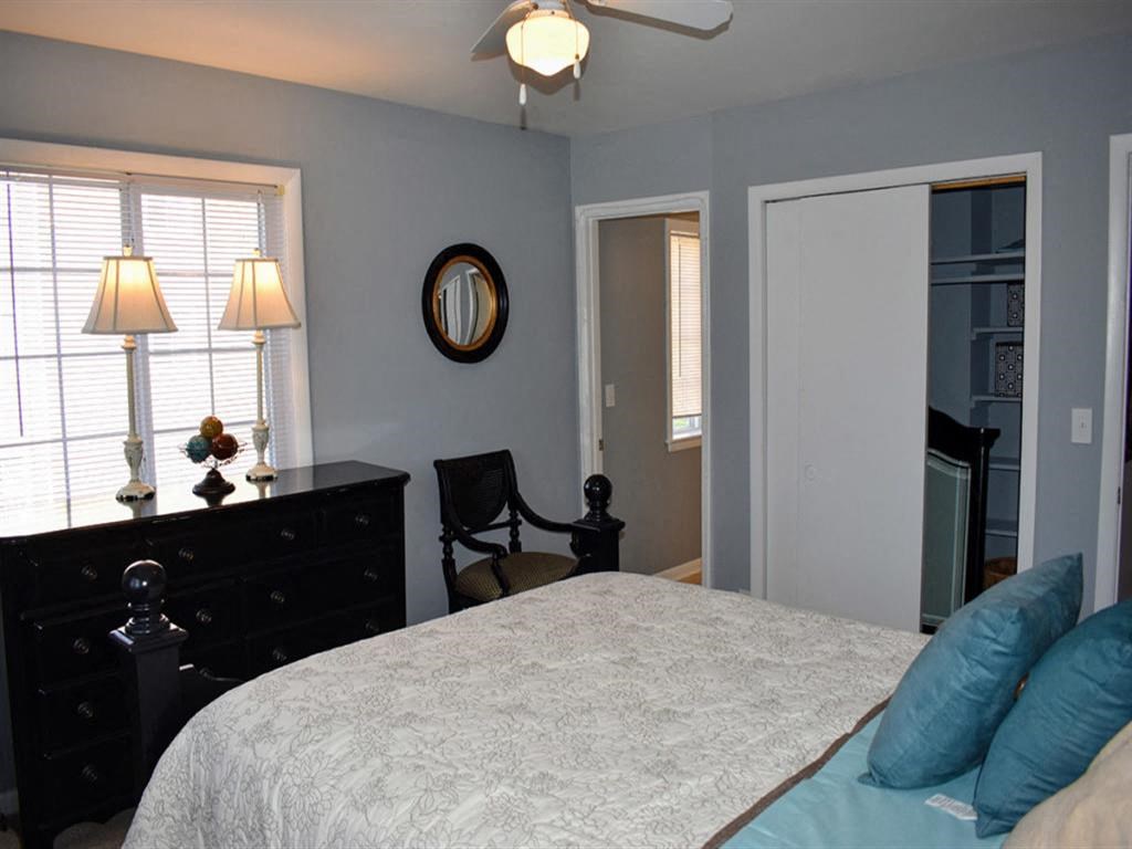 a bedroom with a bed and a dresser and a window