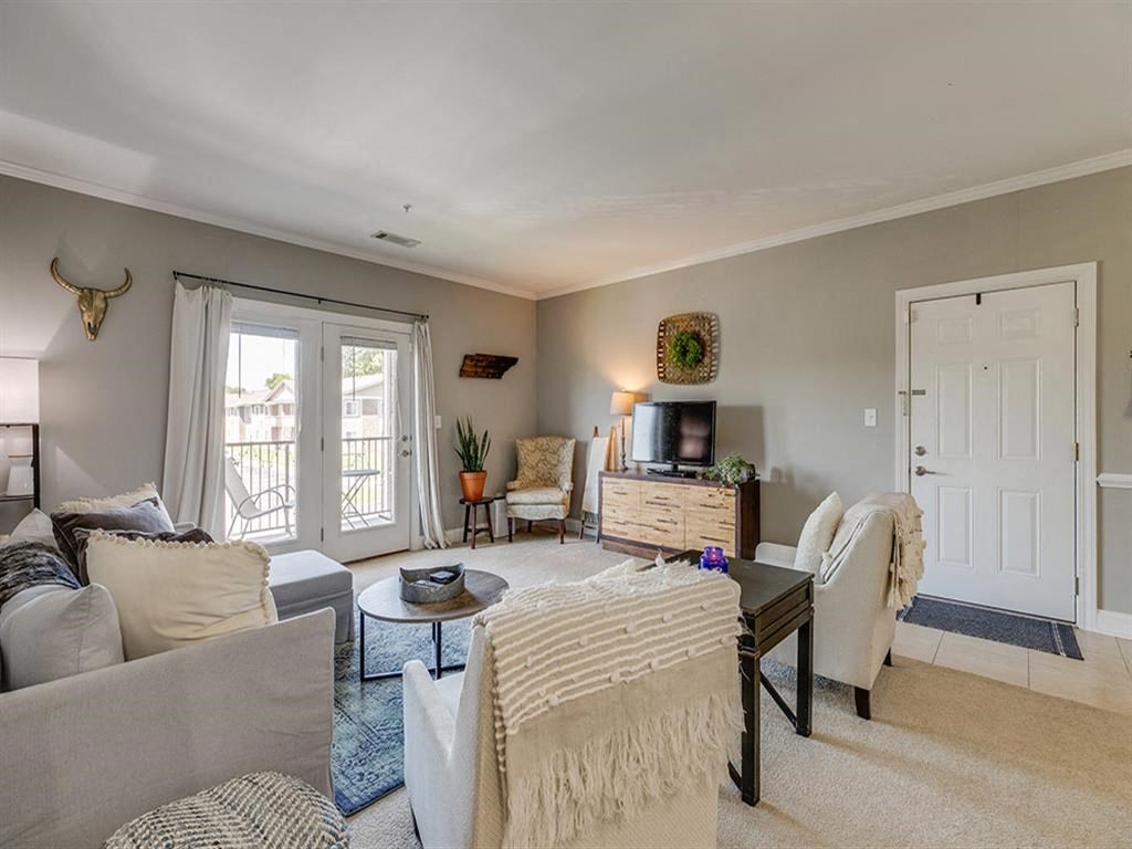 a living room with couches and chairs and a television