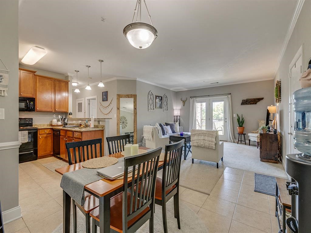 a kitchen and dining room with a table and chairs