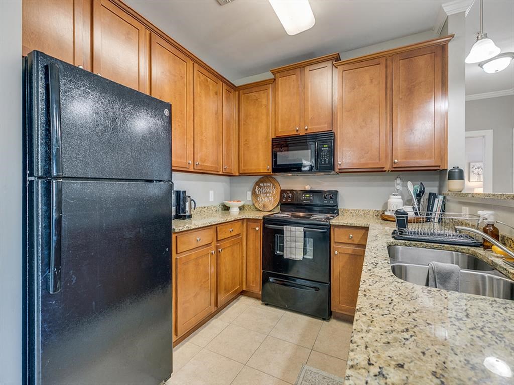 a kitchen with black appliances and granite counter tops
