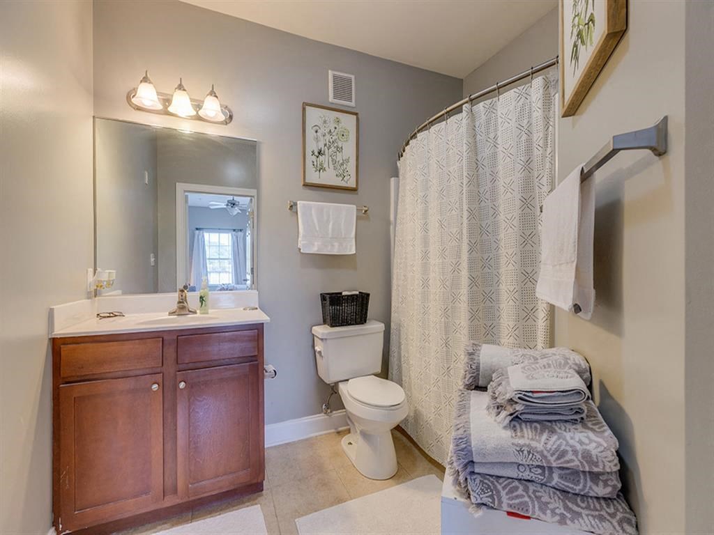 a bathroom with a shower and a toilet and a sink