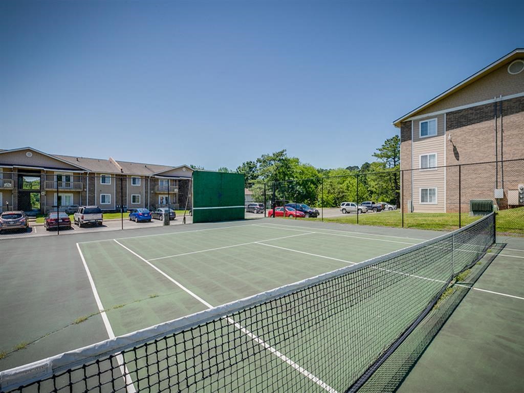 a tennis court in front of a building
