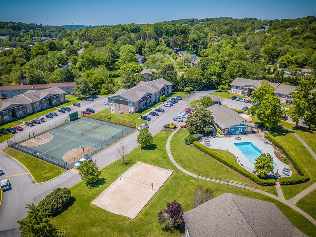 a aerial view of a neighborhood with houses and tennis courts