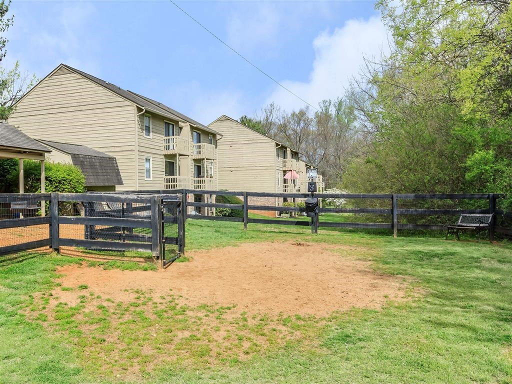 a backyard with a wooden fence and houses