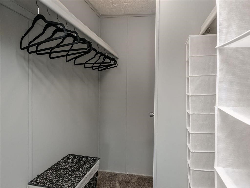 a walk in closet with a shoe rack