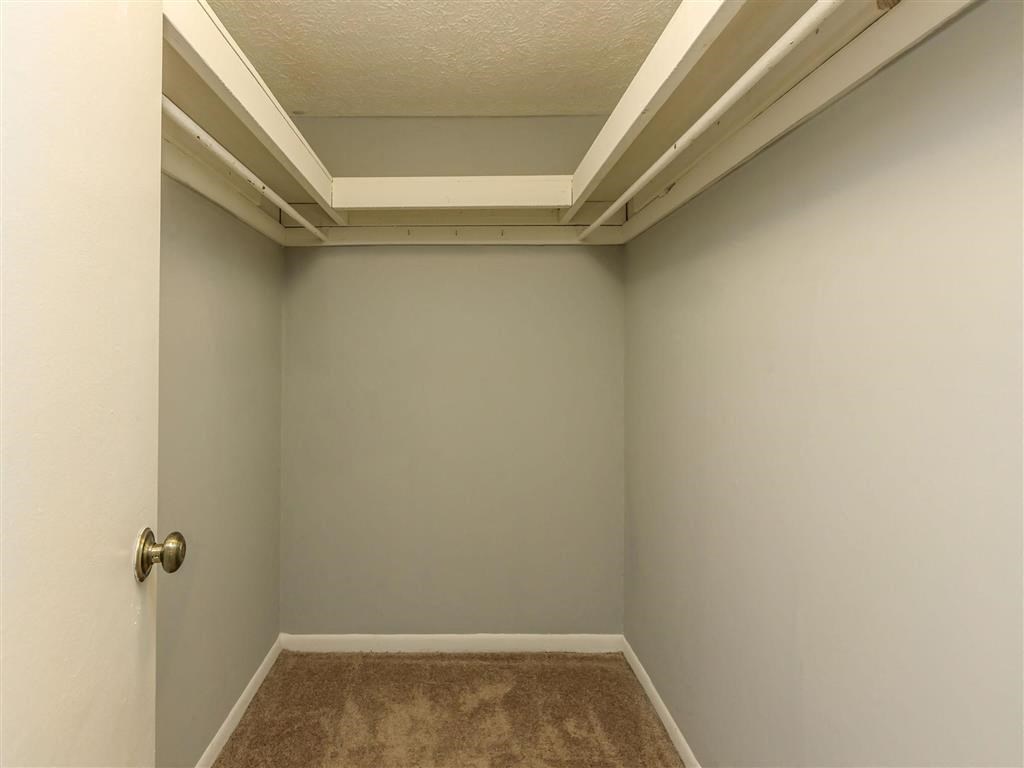 a empty room with a carpet and a door