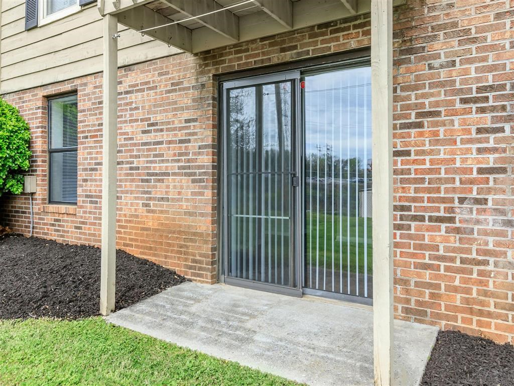 the entrance to a brick building with glass doors
