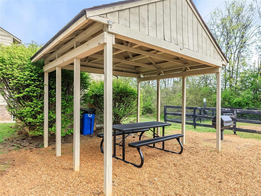 a picnic pavilion with a table and a bench