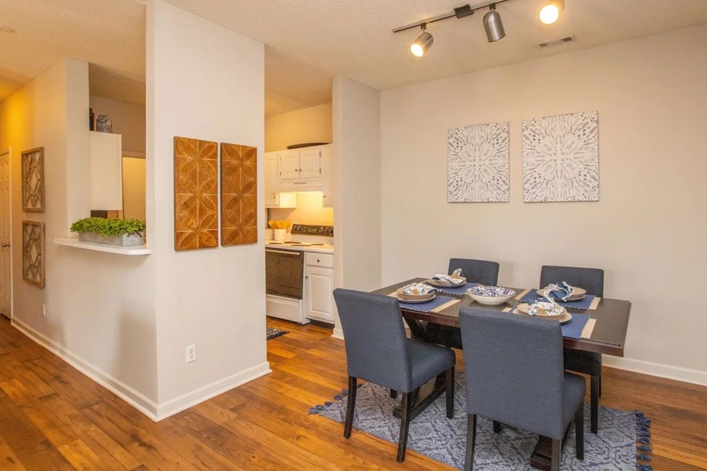A dining room with a table set for four.