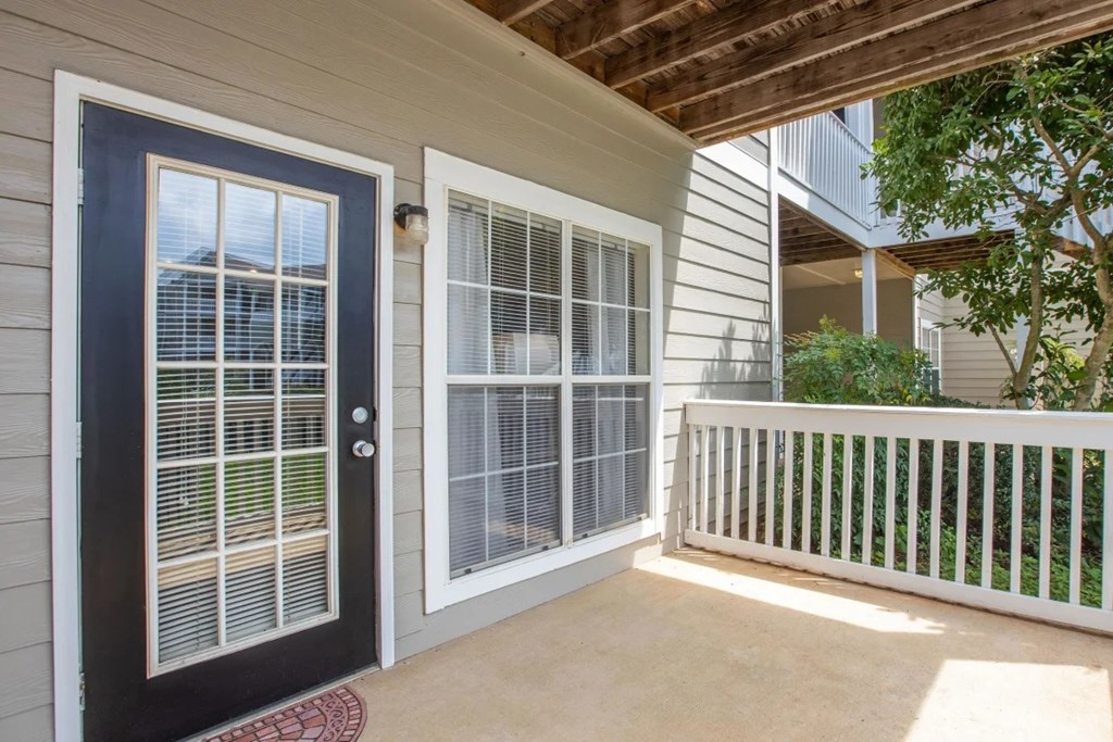 A black door with a window is on the left and a white door with a window is on the right.
