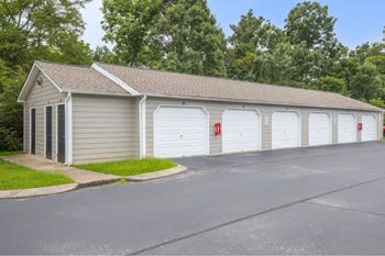 A building with a grey roof and white garage doors.