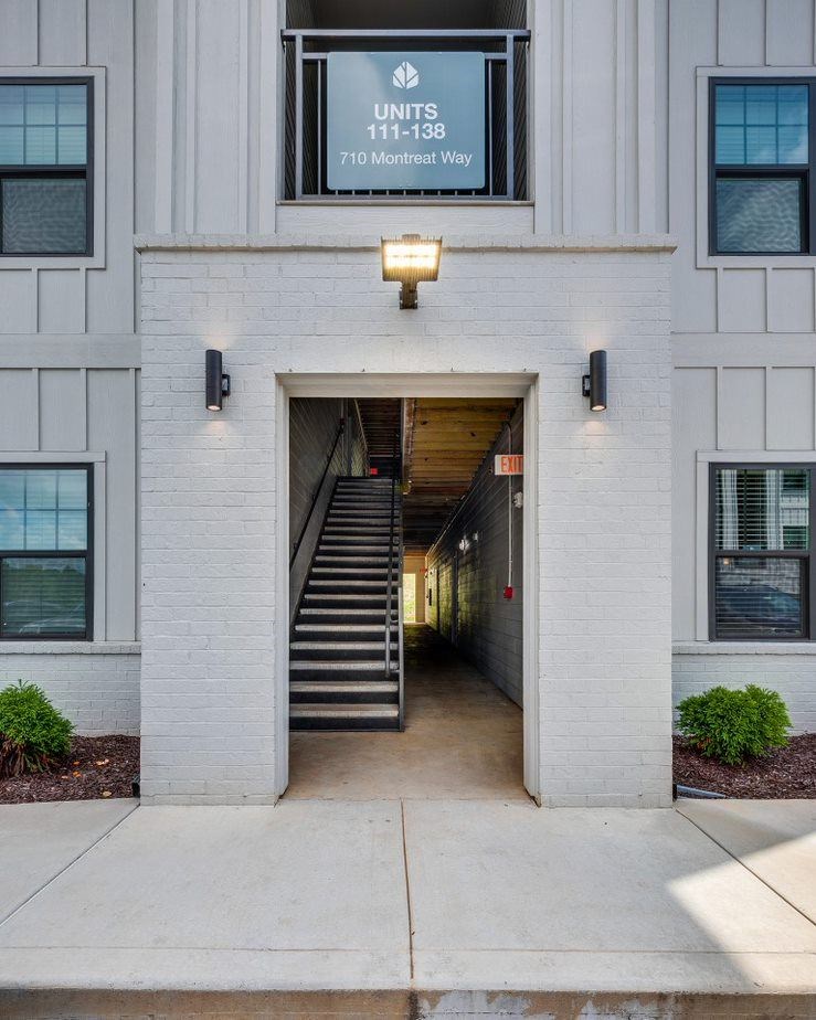 A light grey building with a sign that says UNITS 710 Montreat Way.