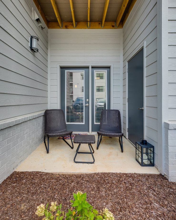 A small patio with a table and two chairs.