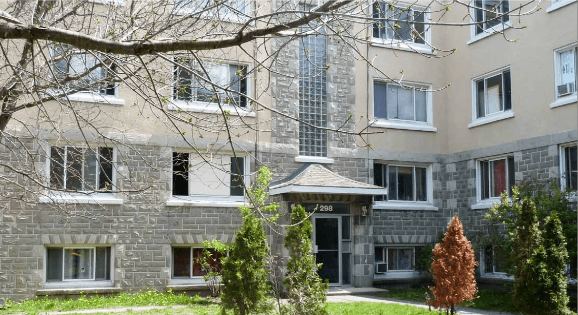 an apartment building with trees in front of it