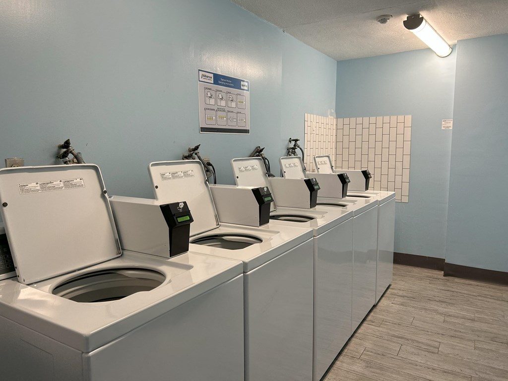 a row of washing machines in a public laundromat