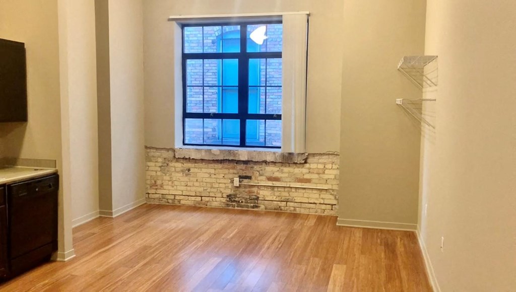 an empty living room with a large window