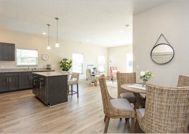 a kitchen and living room with a table and chairs