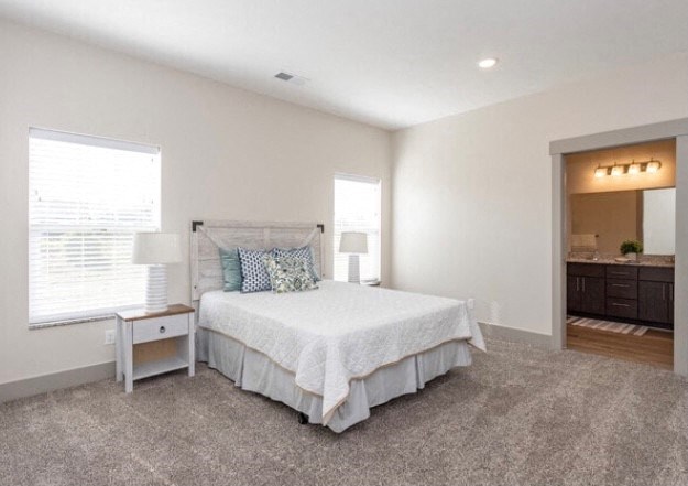 a bedroom with a bed and two windows