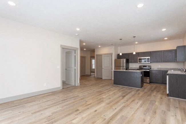 a large living room with a kitchen and a