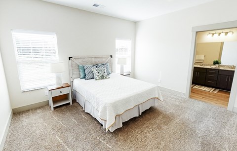 A bedroom with a large bed and a small desk.