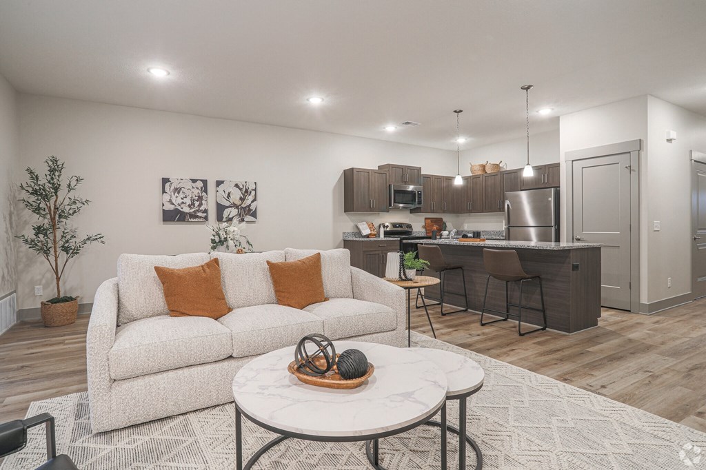A modern living room with a white couch and a coffee table.