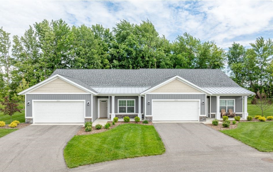 a white house with a driveway and a lawn