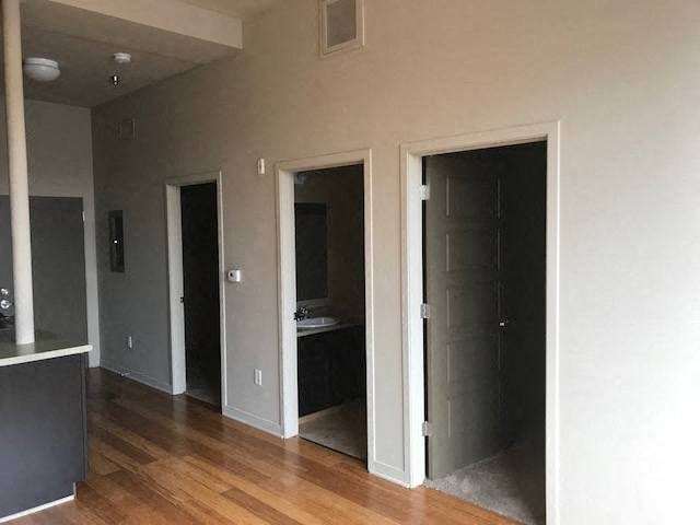 a room with three doors and a sink