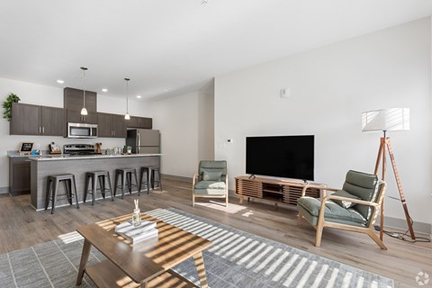 A modern living room with a bar area and a television.