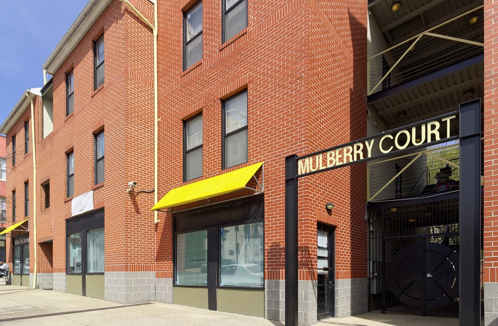 a brick building with a yellow awning and the words murphy court