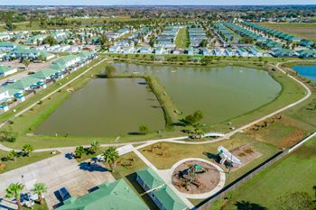 an aerial view of a campground with a lake and a playground