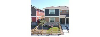 a home with a wooden fence in front of it