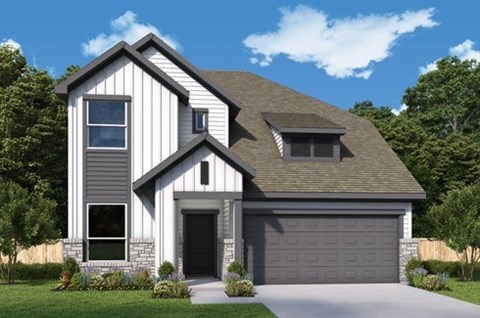 A modern house with a grey garage door and a stone wall.