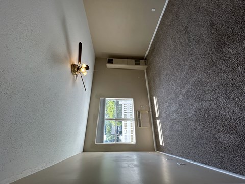 A wall-mounted light fixture with a long arm and a round head.