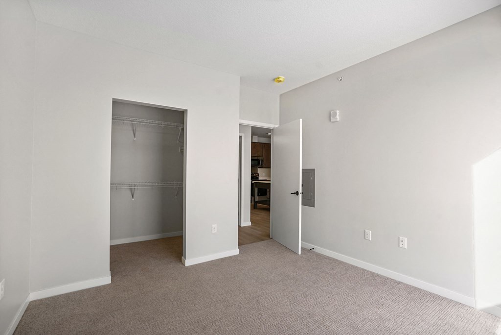 A room with a carpeted floor and white walls.