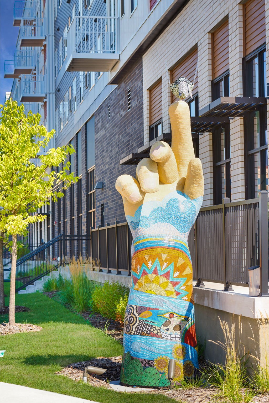 a large statue of a hand holding a engagement ring