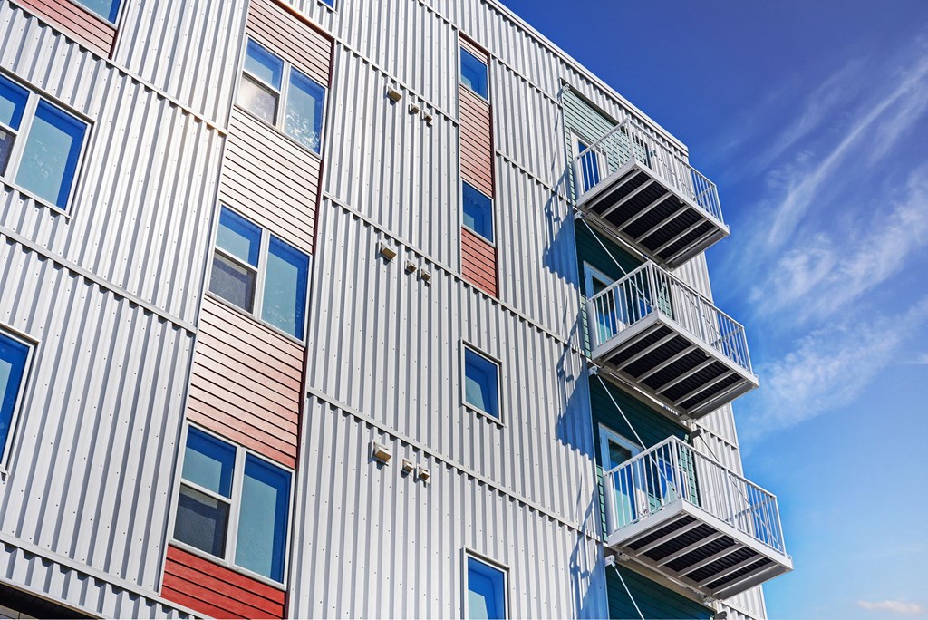 the facade of a modern apartment building with stairwells