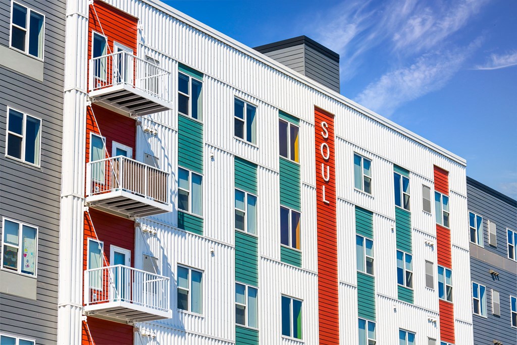 the facade of a hotel with colorful doors and balconies