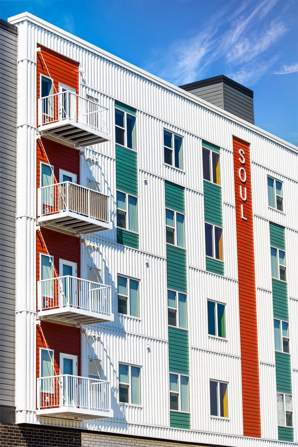 a large white building with green and red doors and