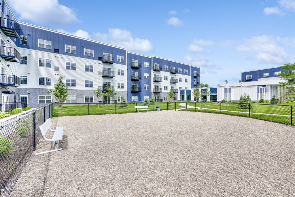 a courtyard with a bench in front of an apartment building