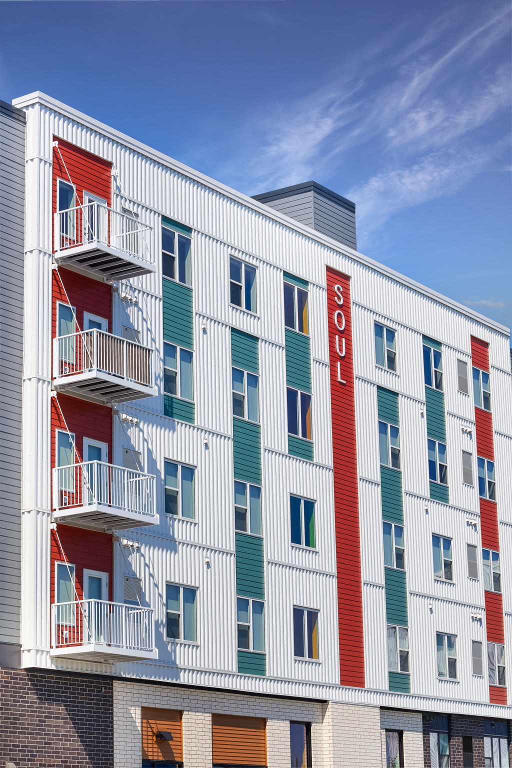 a building with a red and white facade and a blue sky