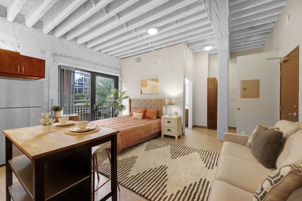 a bedroom with a bed and a table in a room