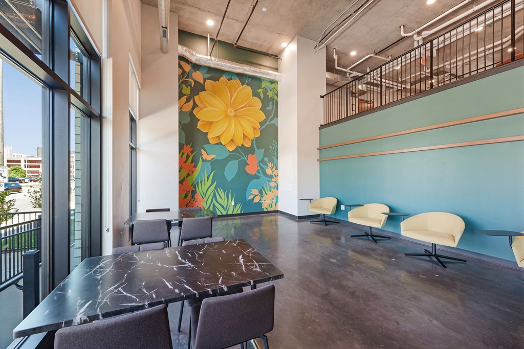 a conference room with a table and chairs and a mural on the wall