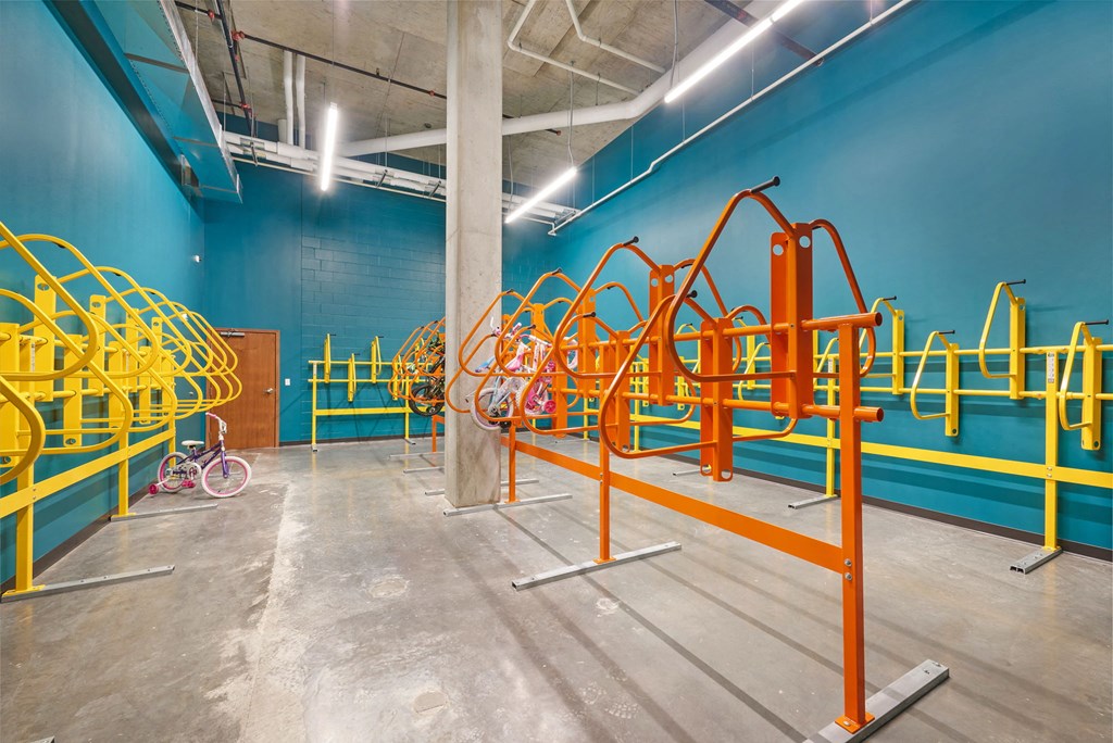 a playground area in a building with blue walls and yellow equipment