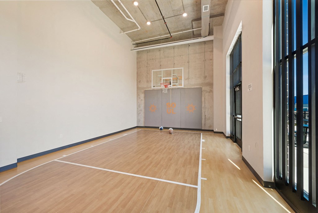 a basketball court in a large room with wood floors