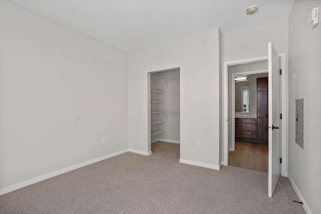 A white room with a doorway leading to another room.