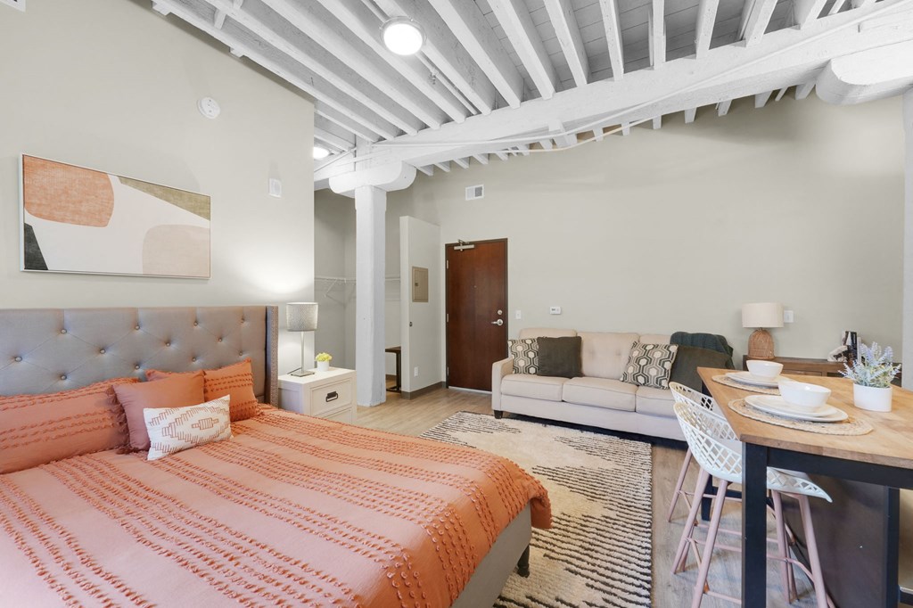 a bedroom with a bed and a couch